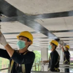 Carbon fiber laminate pada pelat beton existing untuk peningkatan kapasitas ruang